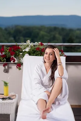 Portrait of gorgeous woman with a towel on my head in a white bathrobe  staying on the balcony in a hotel unaltered Stock Photo by ©ShotStudio  534574168